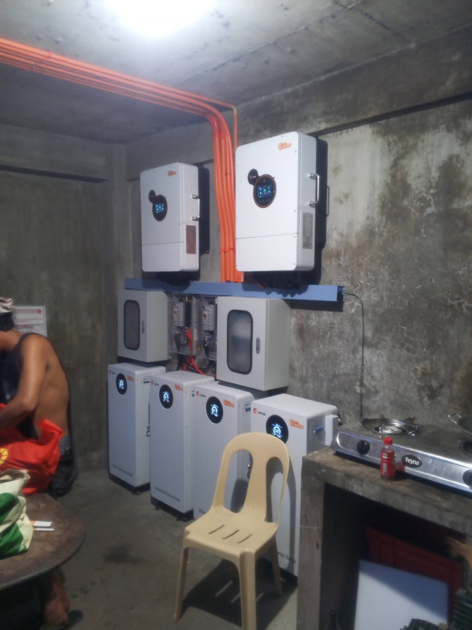 Hybrid inverters and a lithium battery bank mounted and wired in a utility room