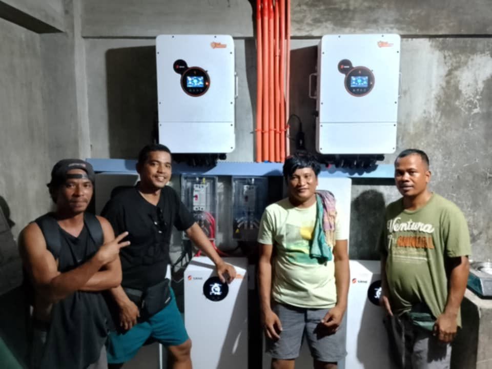 The installation crew in front of a completed twin-inverter solar storage system