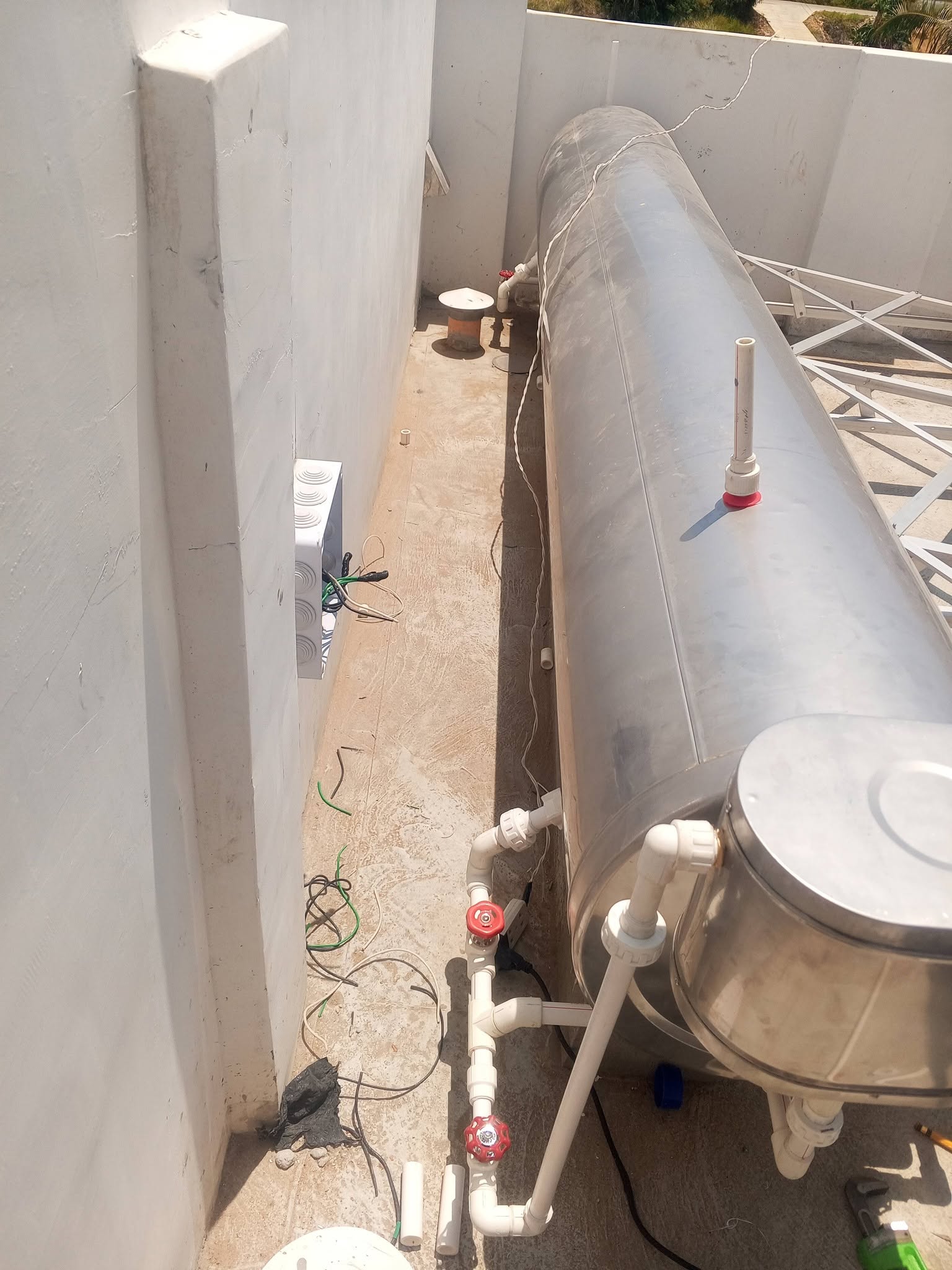 Evacuated-tube solar water heater installed on a rooftop deck