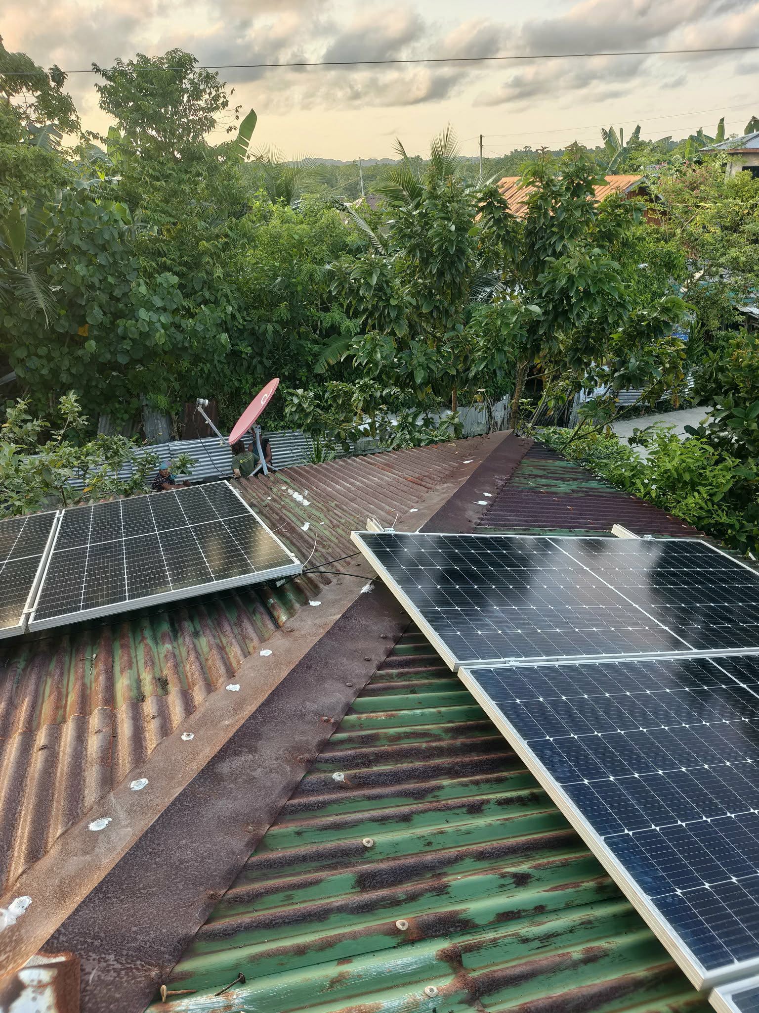 Solar panels installed on a house roof in Siargao at sunset